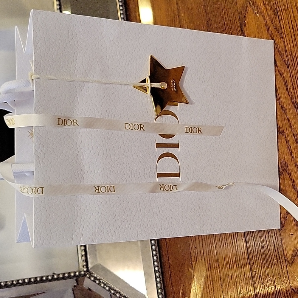 Dior white paper gift bag with gold star charm ornament ribbon